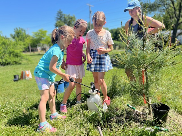 Planting pollinator-friendly plants with C.P. Smith students